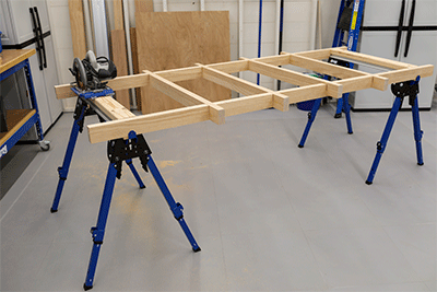 A custom cutting grid spans across two Kreg Track Horses