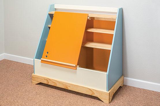 colorful toy box with sliding door that works as an easel