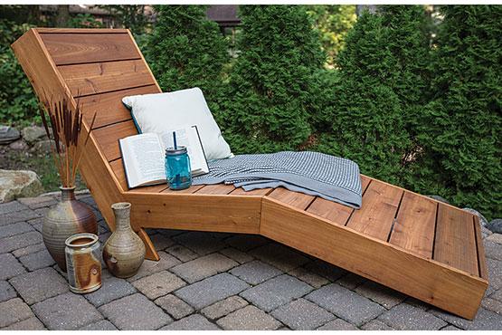 Outdoor chaise lounge with pillows and a drink
