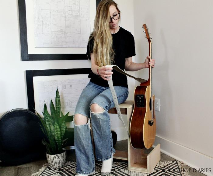 shara-picking-guitar-out-of-stool-stand-small
