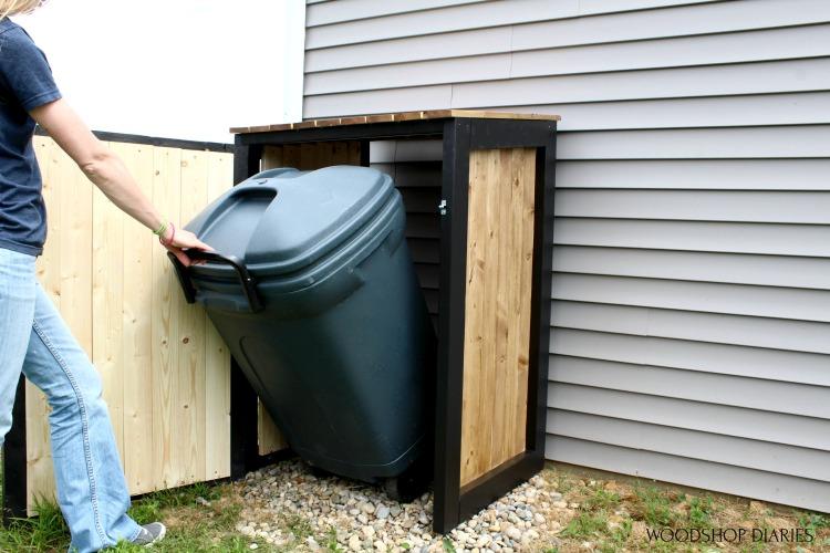 Shara pulling trash can out of cover small