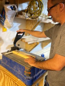 A man uses the Kreg Foreman Pocket-Hole Machine to drill pocket holes
